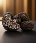 Close-up of truffles on a dark surface with a blurred background