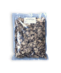 Charcoal-colored cornflakes in clear bag with white label, ideal with dried black summer truffle