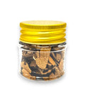 Brown truffle spice jar with yellow lid containing dried black summer truffle Tuber Aestivum