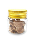 Clear glass jar with yellow lid containing slices of freeze dried white truffle Tuber Magnatum Pico
